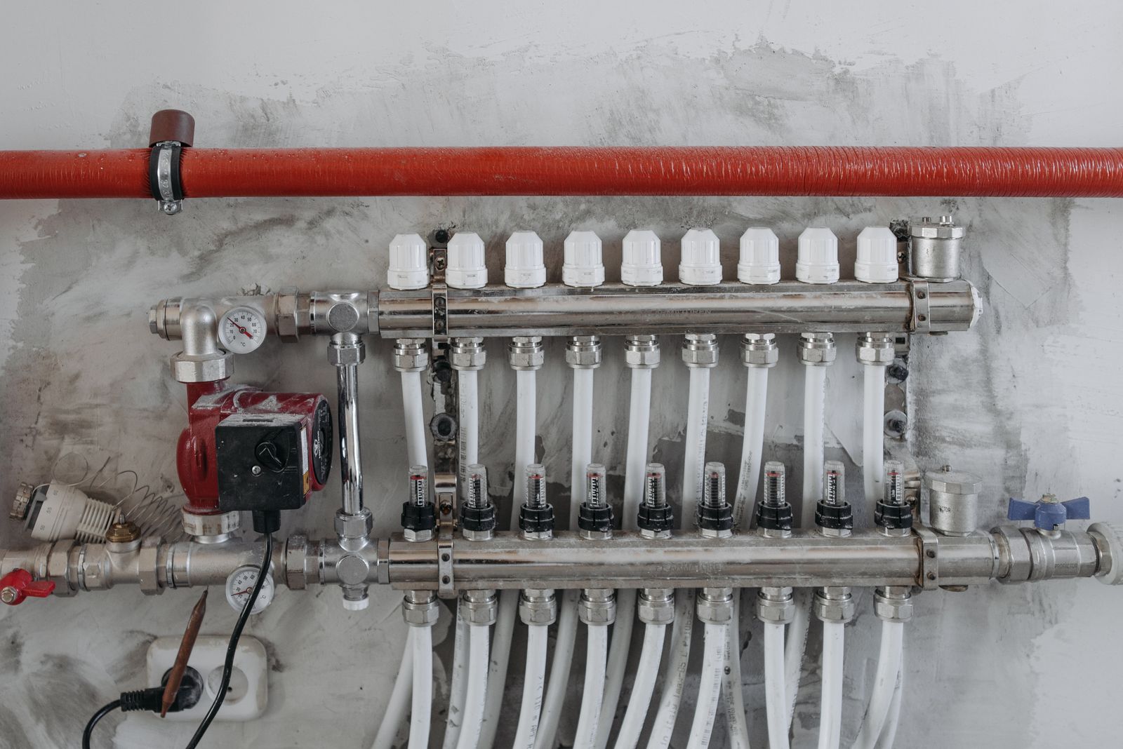 PEX plumbing manifold and supply lines installed during a new construction plumbing rough-in