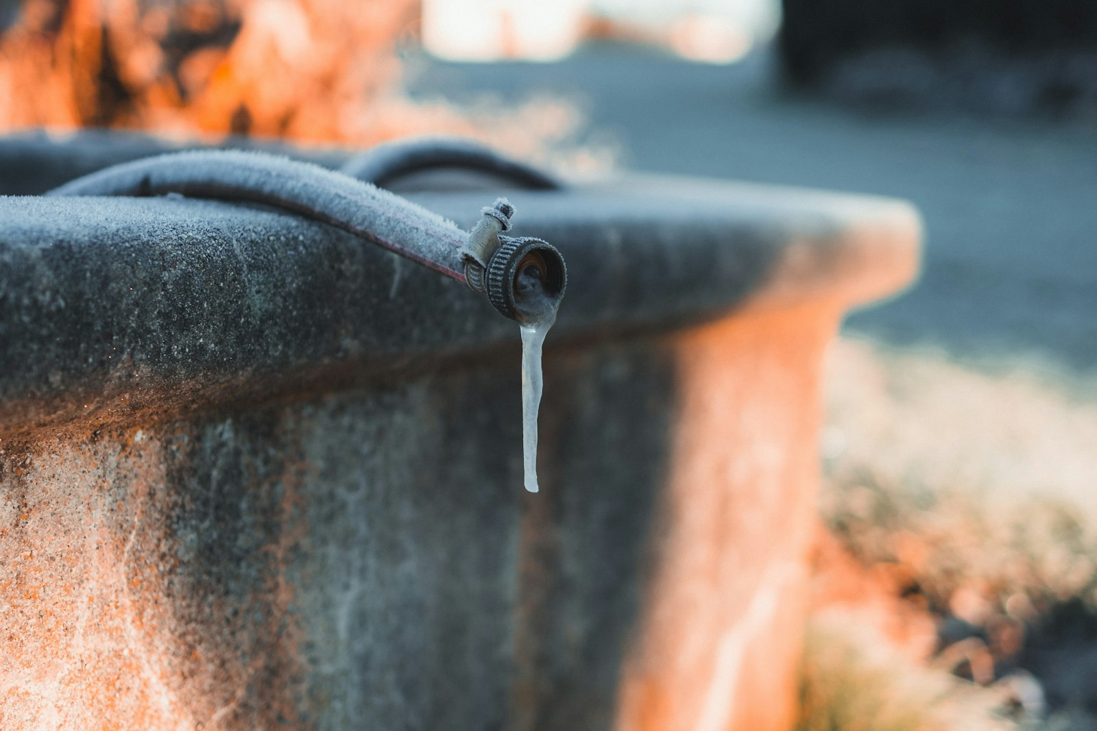 Frozen garden hose and ice on an outdoor faucet, the most common cause of frozen pipes in Kitsap County WA